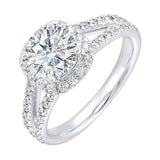 Cushion halo showcases a round solitaire, enhanced by a modern split diamond-studded shank.