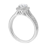Cushion halo showcases a round solitaire, enhanced by a modern split diamond-studded shank.
