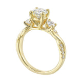Round solitaire with smaller side diamonds atop a crisscross band with flowing diamond accents.