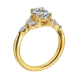 Elongated oval center framed by marquise diamond trios on each side and a pinched shank.