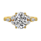 Elongated oval center framed by marquise diamond trios on each side and a pinched shank.