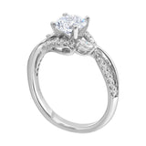 Nature-inspired three-stone ring with an intertwined design of pavé diamonds and polished metal.