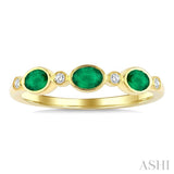 4X3 MM Oval Shape Emerald and 1/20 Ctw Bezel Set Round Cut Diamond Precious Fashion Band in 10K Yellow Gold